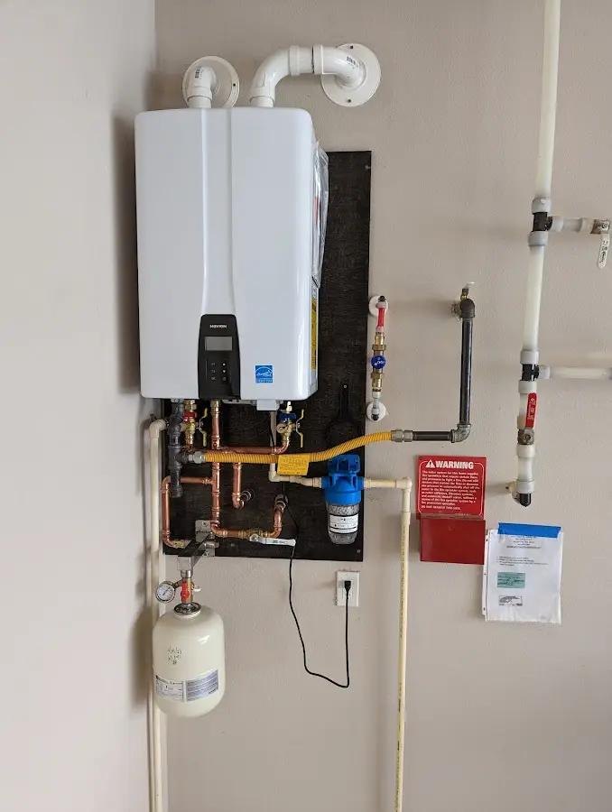 Professional plumber installing copper piping in a Garner home